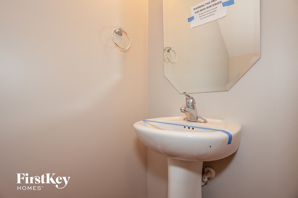a small bathroom with a sink and a mirror
