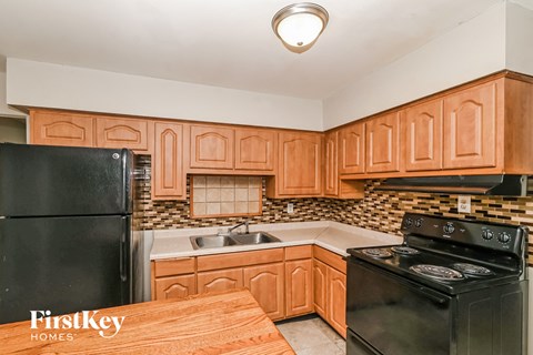 a kitchen with black appliances and wooden cabinets