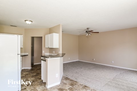 A kitchen area with a counter and a refrigerator.
