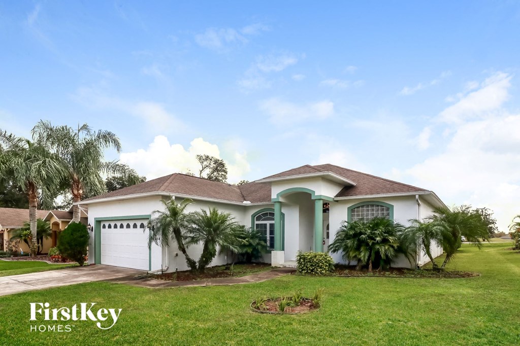 a house with palm trees in front of it