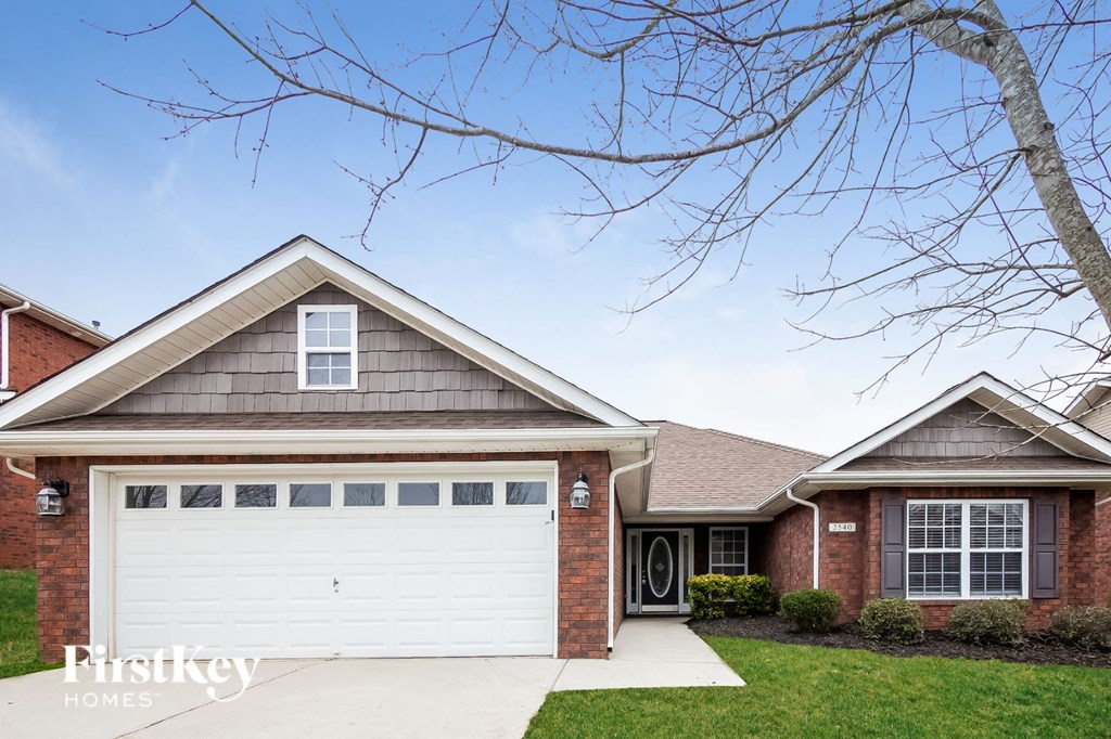 A two-story house with a garage is for sale.