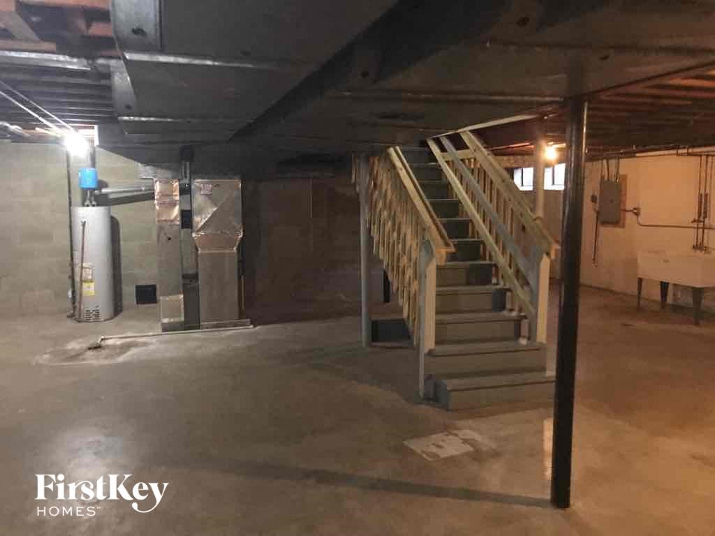 an empty basement with stairs in a building