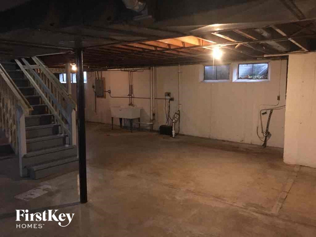 an empty basement with stairs and a stairwell
