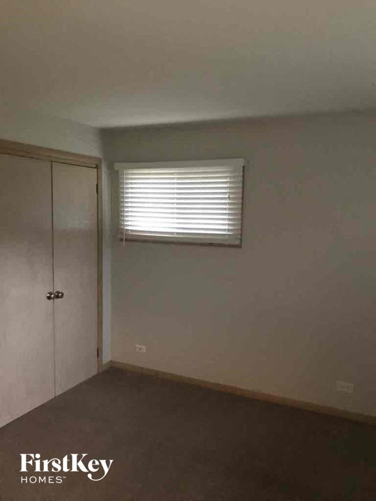 an empty room with a window and a door