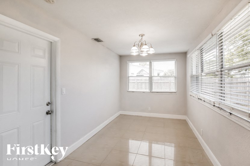 a large empty room with a white door and window