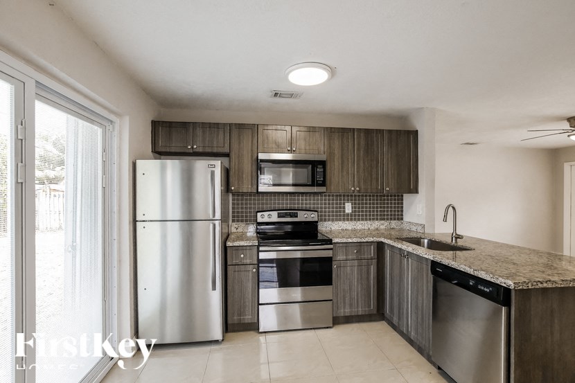 a kitchen with stainless steel appliances and a counter top