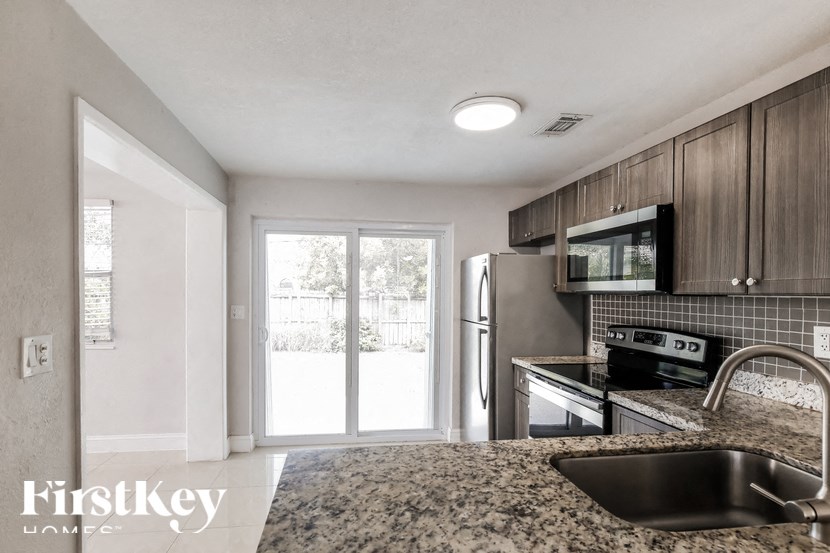 a kitchen with stainless steel appliances and granite counter tops