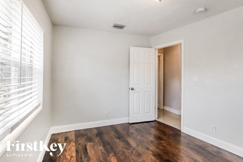 a living room with a white door and a large window