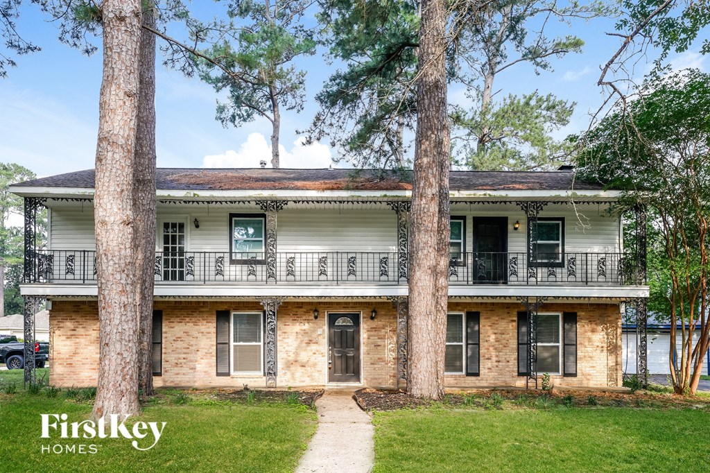 a white house with two trees in front of it