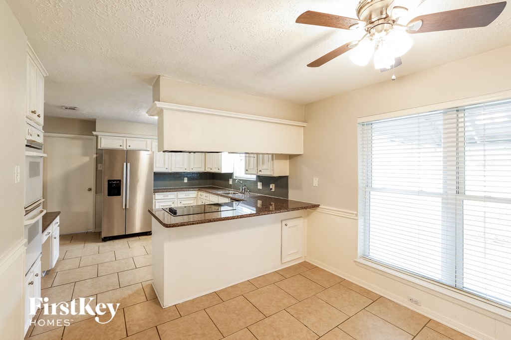 a kitchen with a large window and a counter top