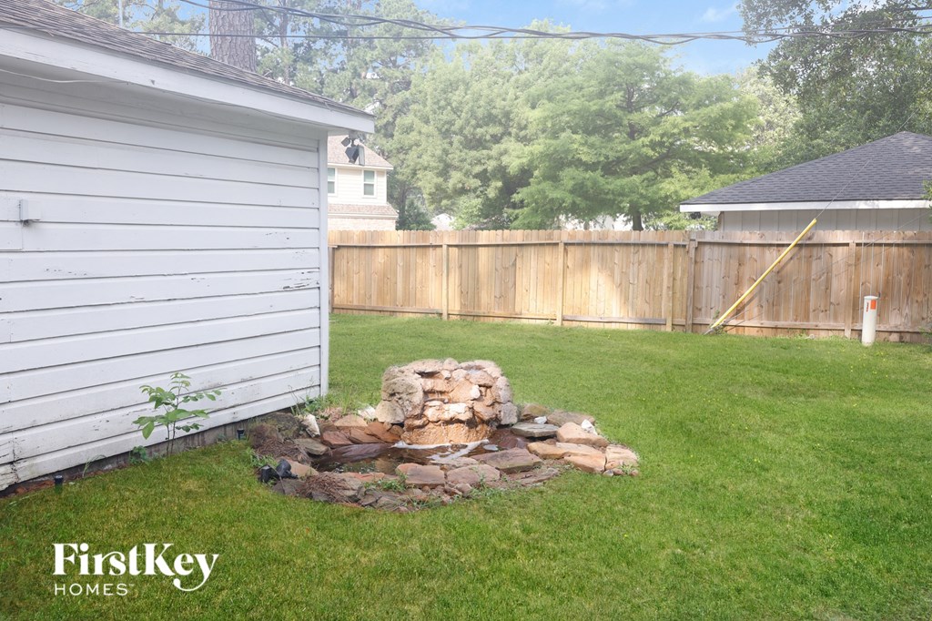 a pile of rocks in the backyard of a house