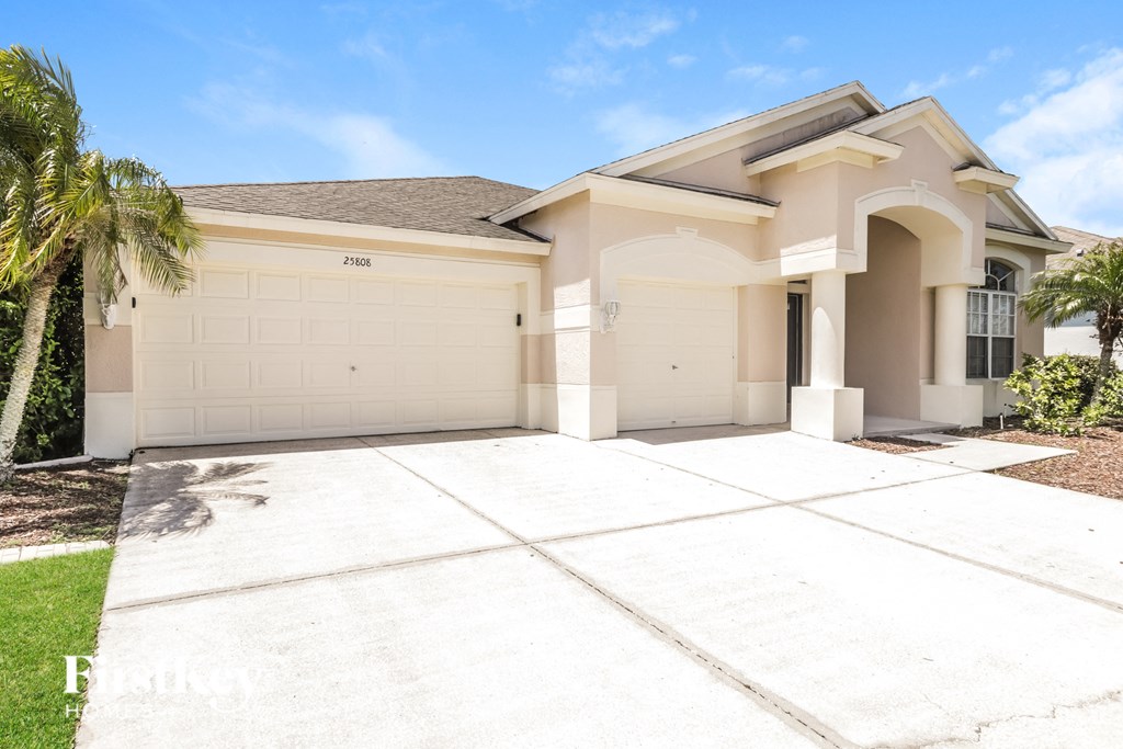 a house with a white garage door and a driveway