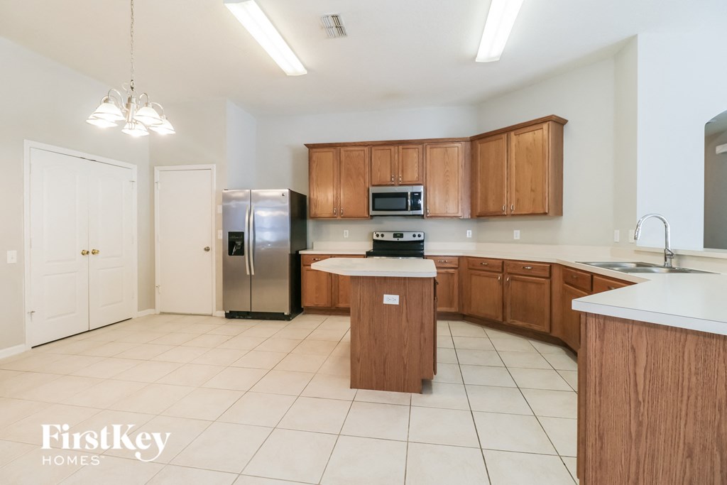 a kitchen with wooden cabinets and stainless steel appliances