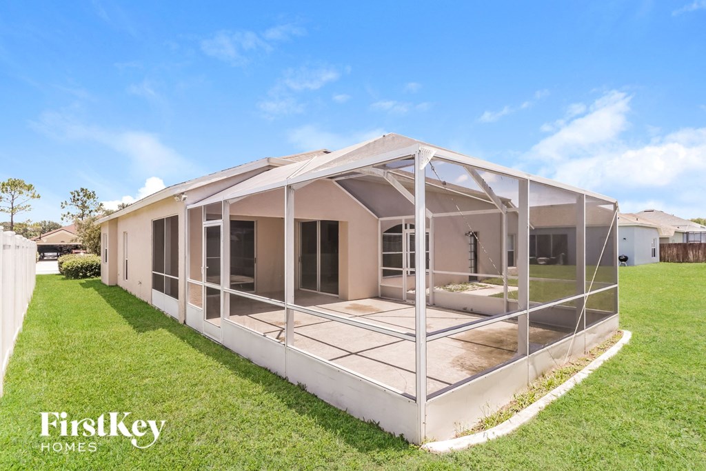 a house with a screened porch and a lawn