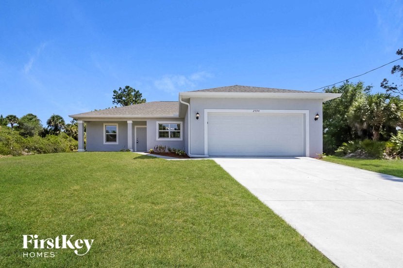 A two-story house with a garage is for sale.