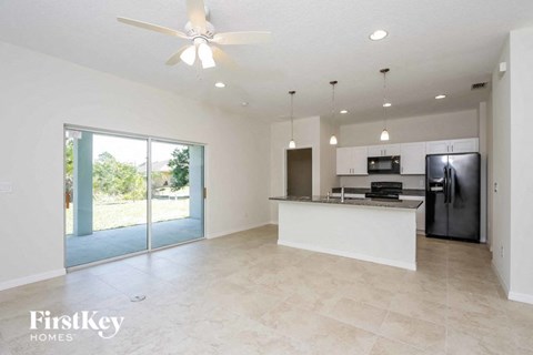 A spacious kitchen with a refrigerator, microwave, and oven.
