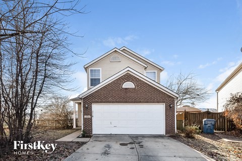 a brick house with a white garage door