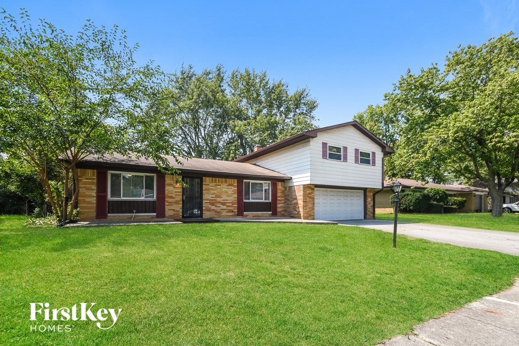 A house with a white garage door is for sale.