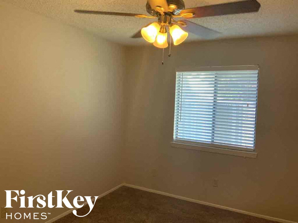 a room with a ceiling fan and a window