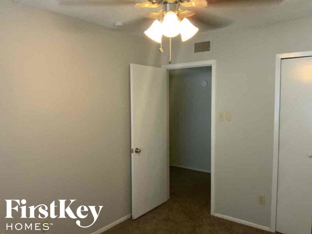 an empty room with a closet and a ceiling fan
