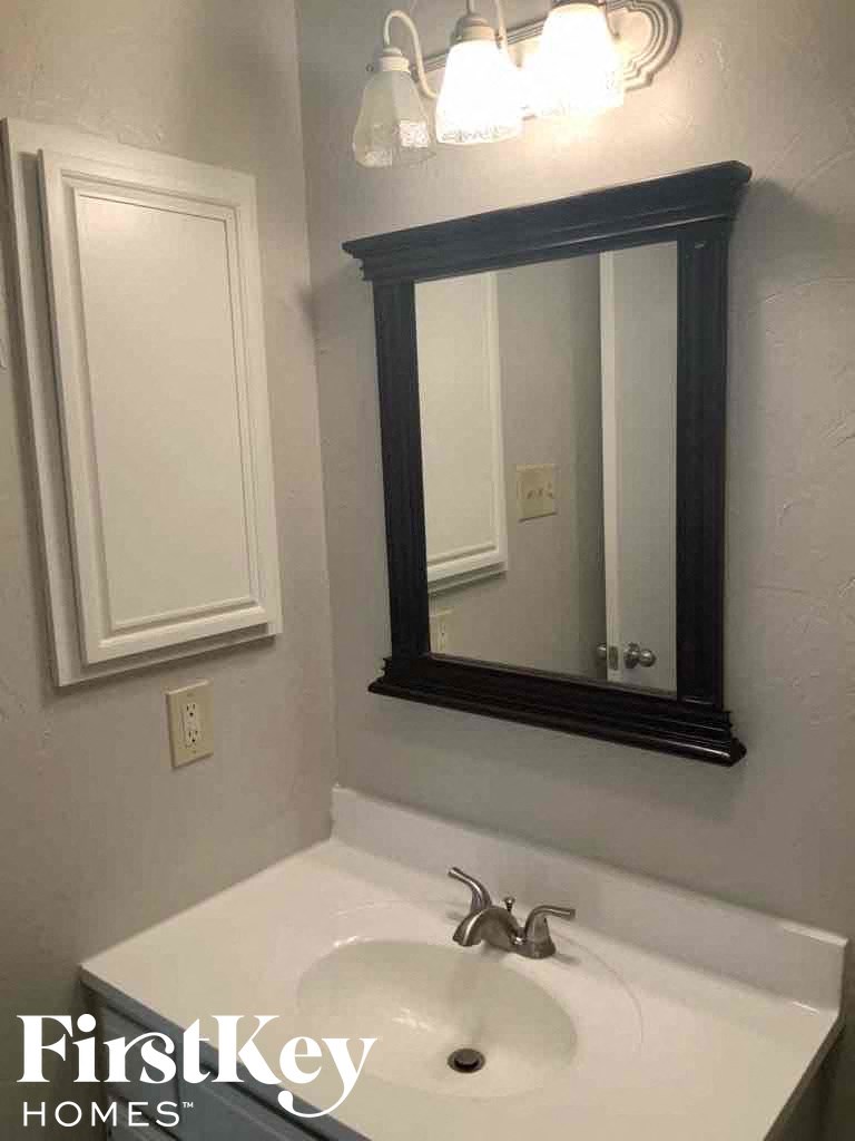 a bathroom with a mirror and a sink