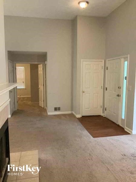 A room with a fireplace and two doors.