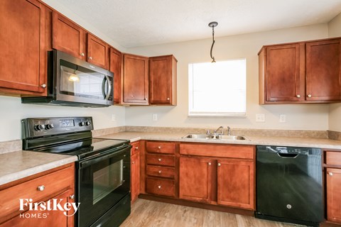 a kitchen with black appliances and wooden cabinets