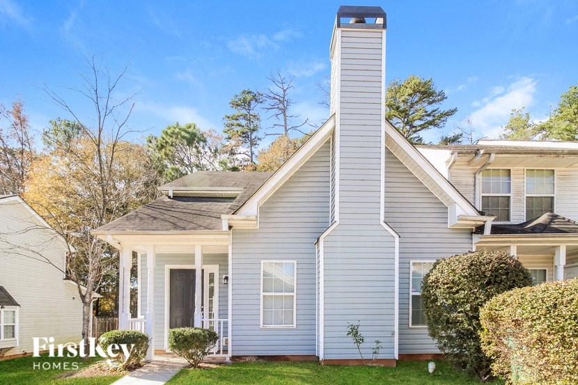 A house with a chimney and a porch is for sale.