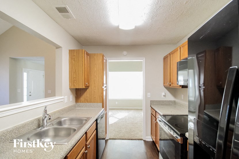 A kitchen with wooden cabinets and a sink.