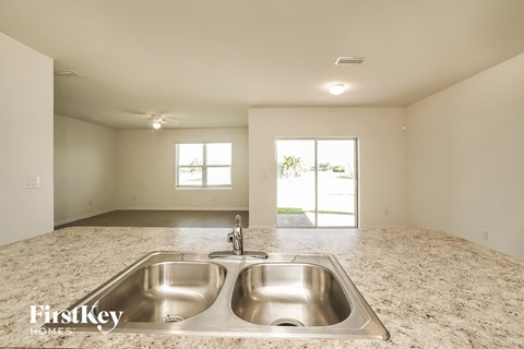 A kitchen with a double sink and a window.