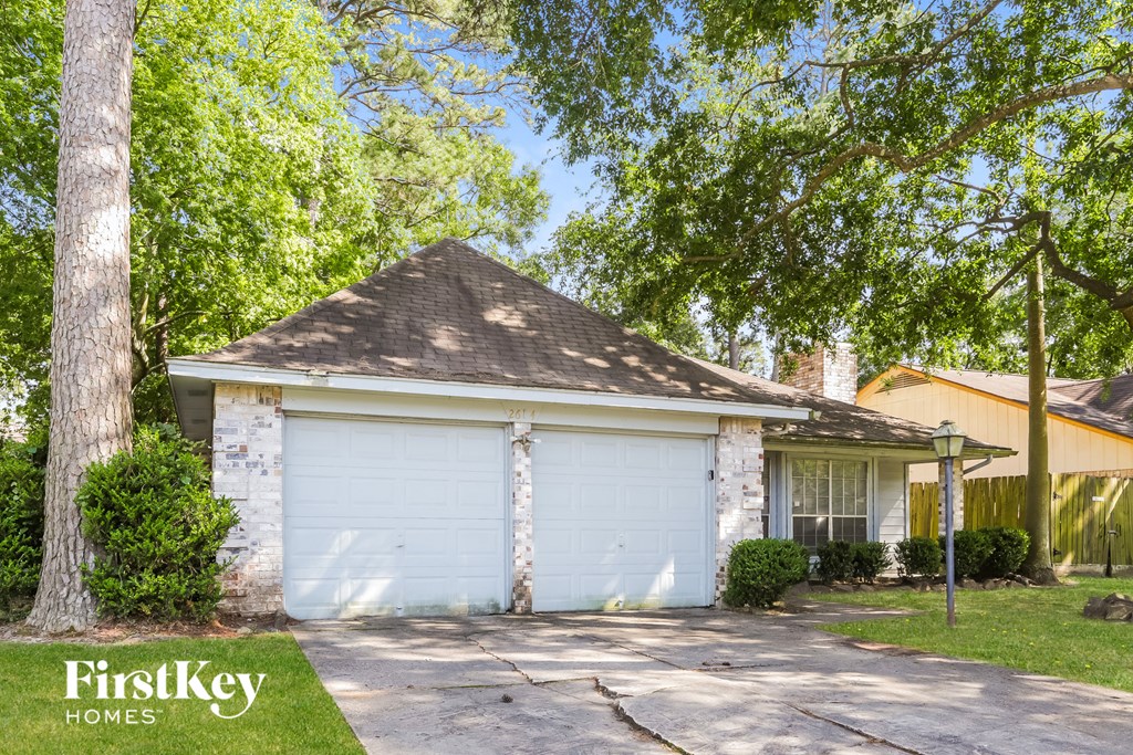 a white brick house with a white garage door
