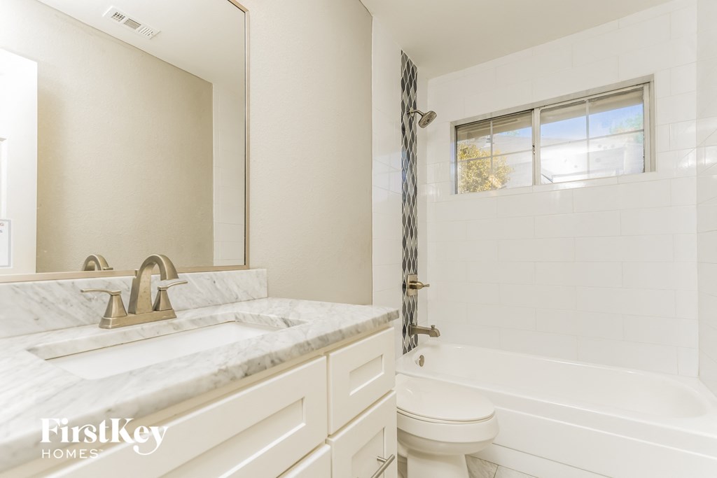 a bathroom with a sink and a toilet and a tub