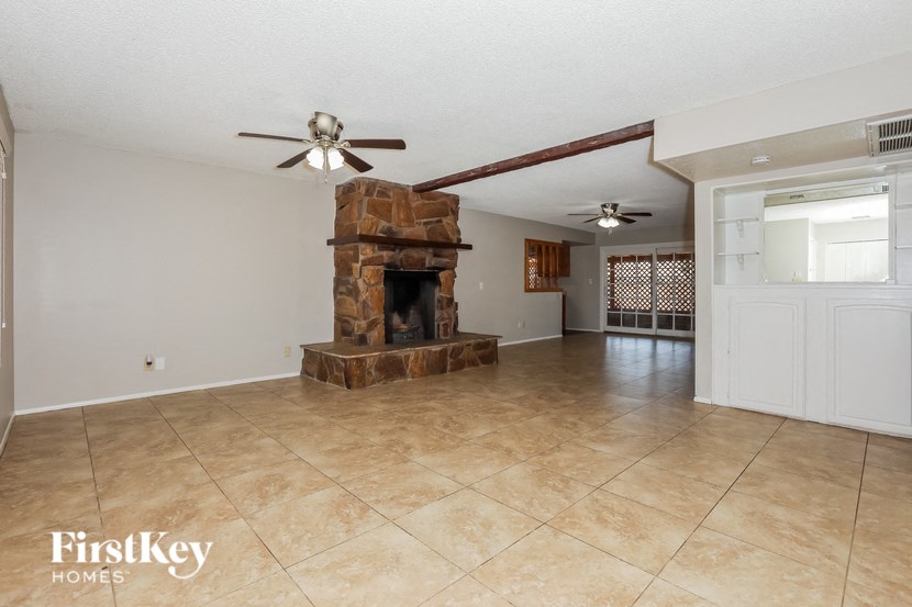 a living room with a fireplace and a tile floor