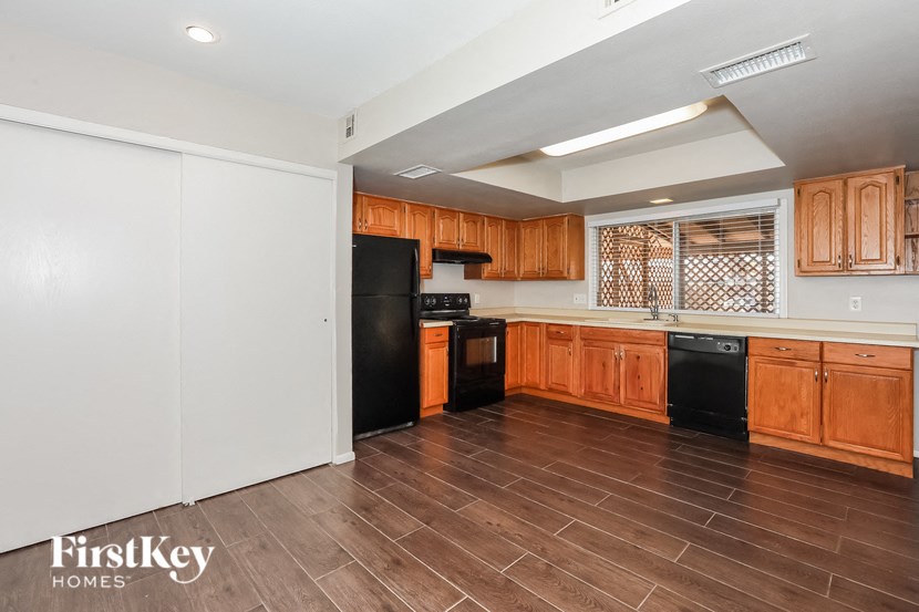 a kitchen with wooden cabinets and black appliances
