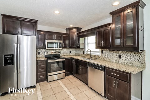 a kitchen with wooden cabinets and stainless steel appliances