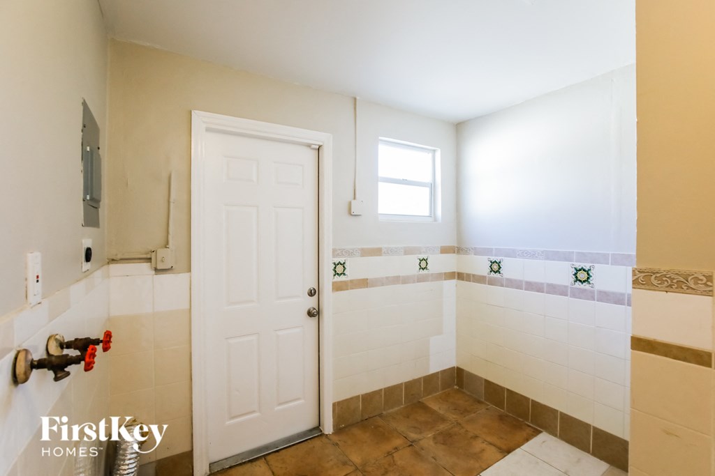 a small bathroom with a shower and a white door
