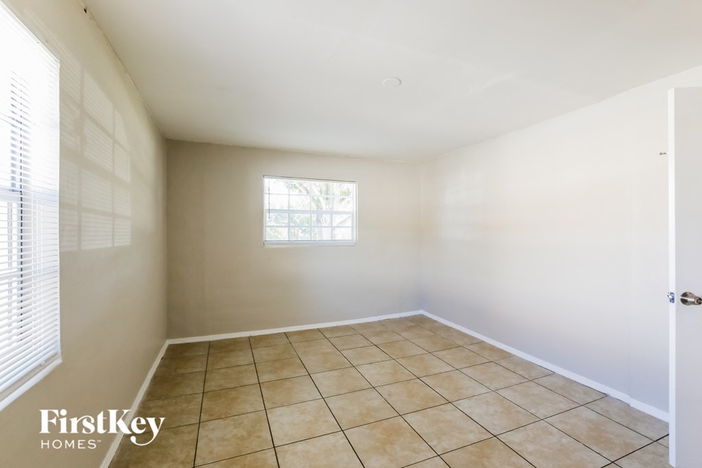 a empty room with tiled floors and a window