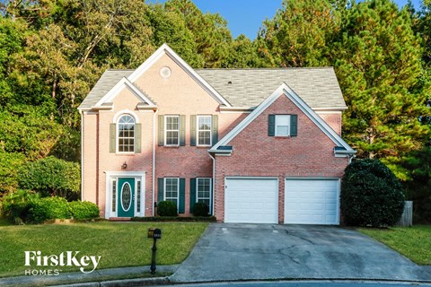 a brick house with a white garage door