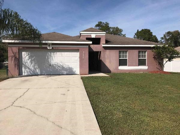 A house with a white garage door and a brown roof.