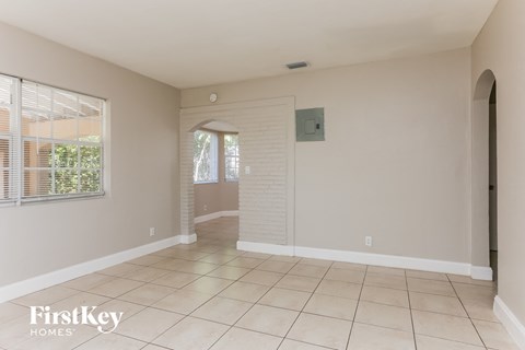 A spacious room with a tiled floor and a sliding door.