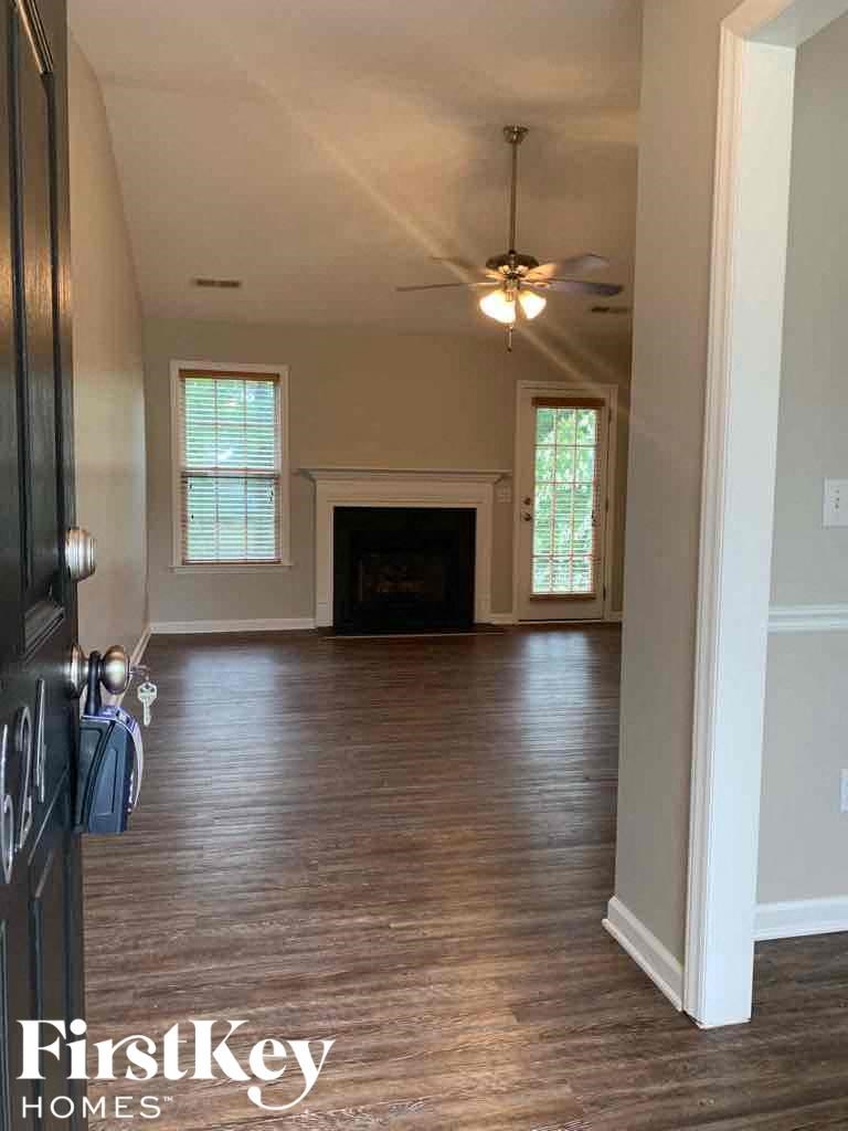 A room with a fireplace and a ceiling fan.