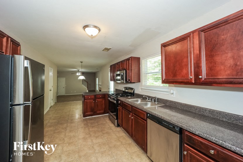 a kitchen with wooden cabinets and stainless steel appliances