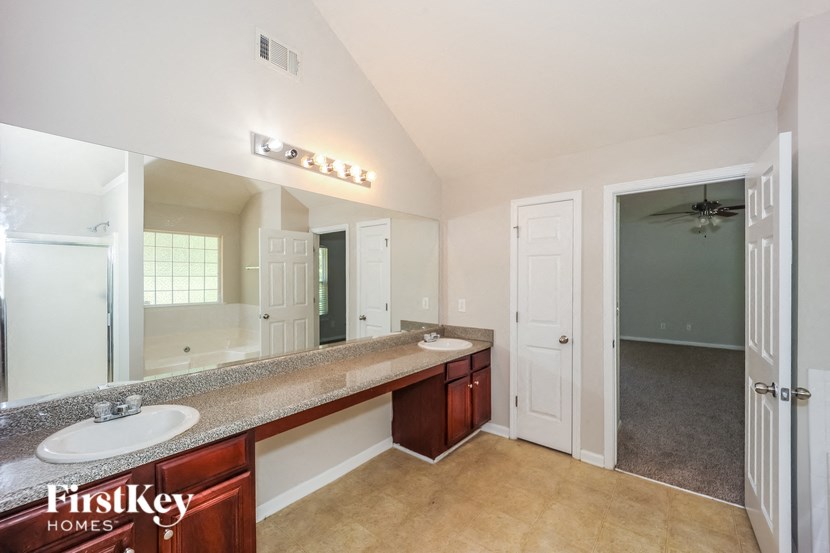a bathroom with two sinks and a large mirror