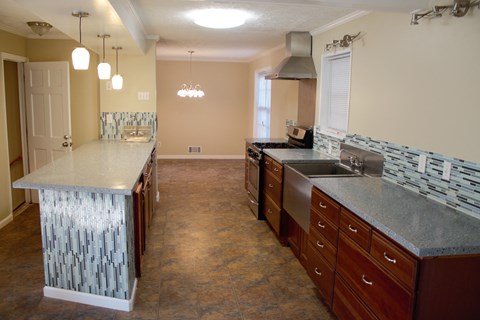A kitchen with a counter top and a sink.