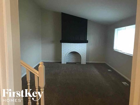 a living room with a fireplace and a tv