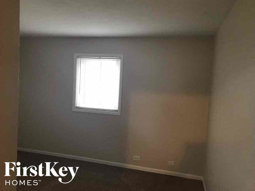 a room with white walls and a window