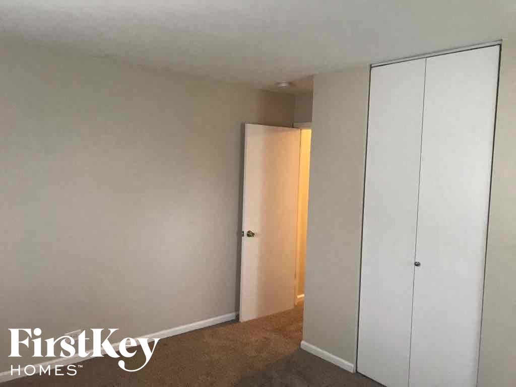 a bedroom with a closet and a door to a closet