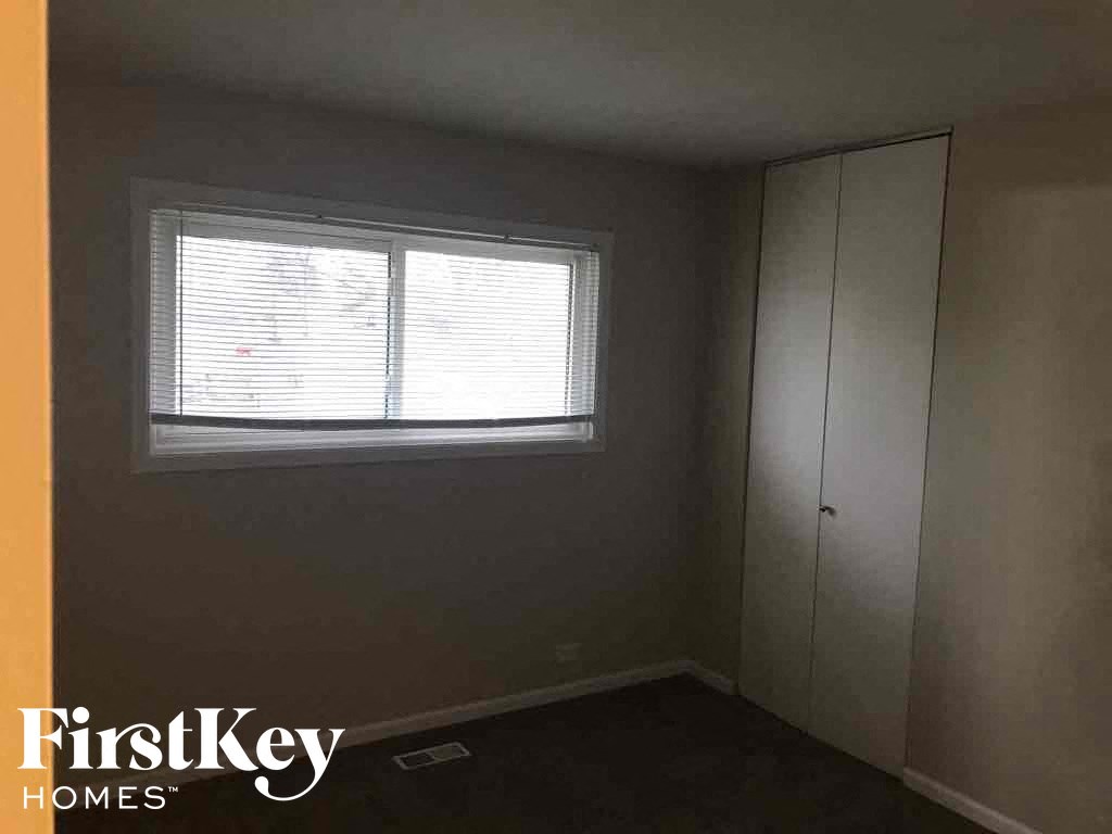 a small room with a window and a closet