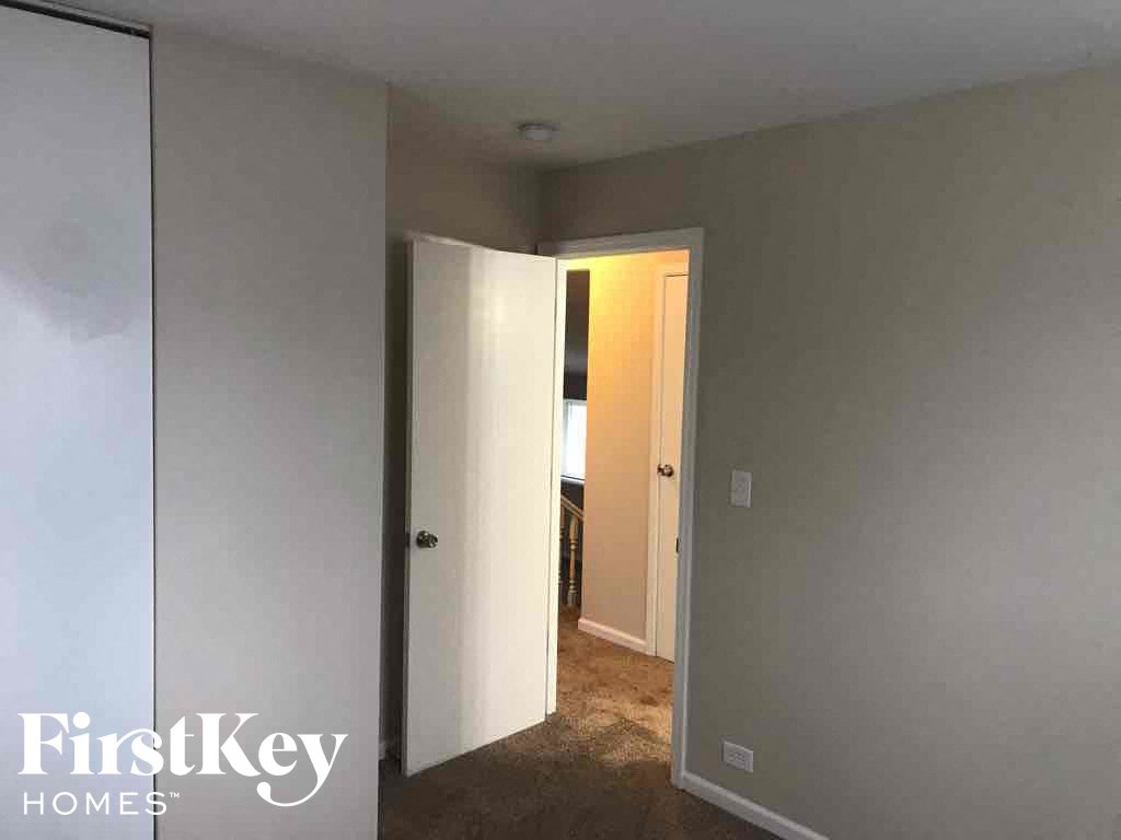 a bedroom with a closet and a door to a bathroom