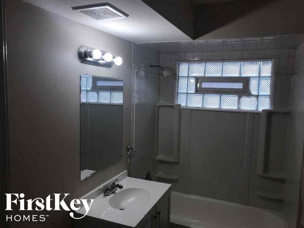 a small bathroom with a sink and a mirror